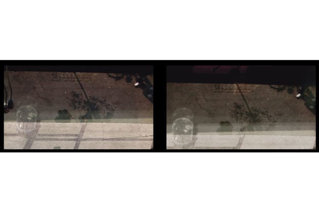 A video still of two images, side by side, with a black border. Each image depicts a blurry glass on the edge of a stone ledge. Beneath the ledge, two people and the reflection of a tree are visible. On the top of each image is a dark rectangular shadow. The difference between the two images is their angle and the image on the left depicts more of the stone ledge while the image on the right depicts more of the shadow, including a reflected magenta element.