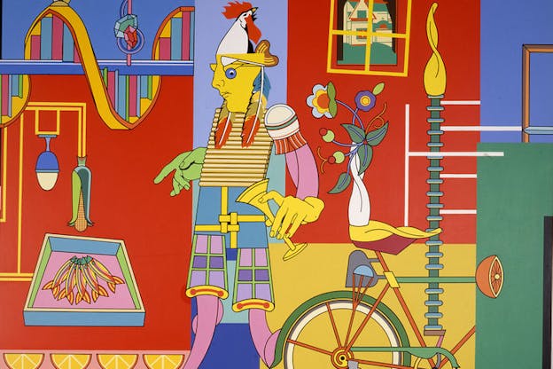 Collage of solid colors of red, blue and yellow. Objects such as oranges, books, flowers,fish and a bicycle are scattered around. The mask of a statue holds the head of a rooster on top of it.