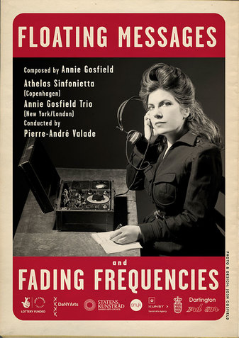 The same black and white image of Gosfield sitting at a table. The border of the image is made of thick red bands which read 