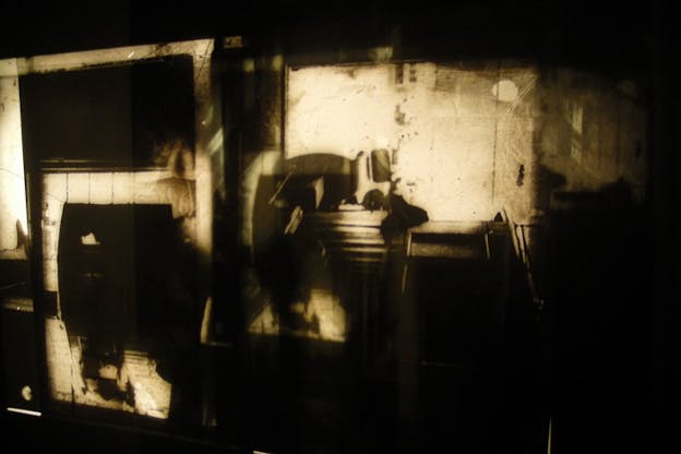 Sepia shapes and shadows superimposed with black abstract shadows. 