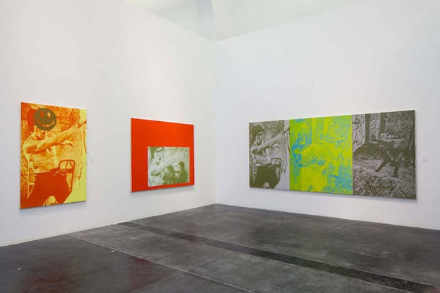 Three screenprints of the same Bruce Lee fighting still in orange, green, and gray monochrome hues. One canvas juxtaposes Lee with a smiley-face, another with a bright red backdrop, and the third with two blurry motion shots in neon yellow and blue and gray hues. 