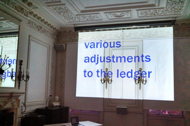 A projection with a white background the phrase 