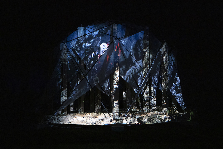 Projection of debris, rocks, signs and flames on triangular panels on columns.