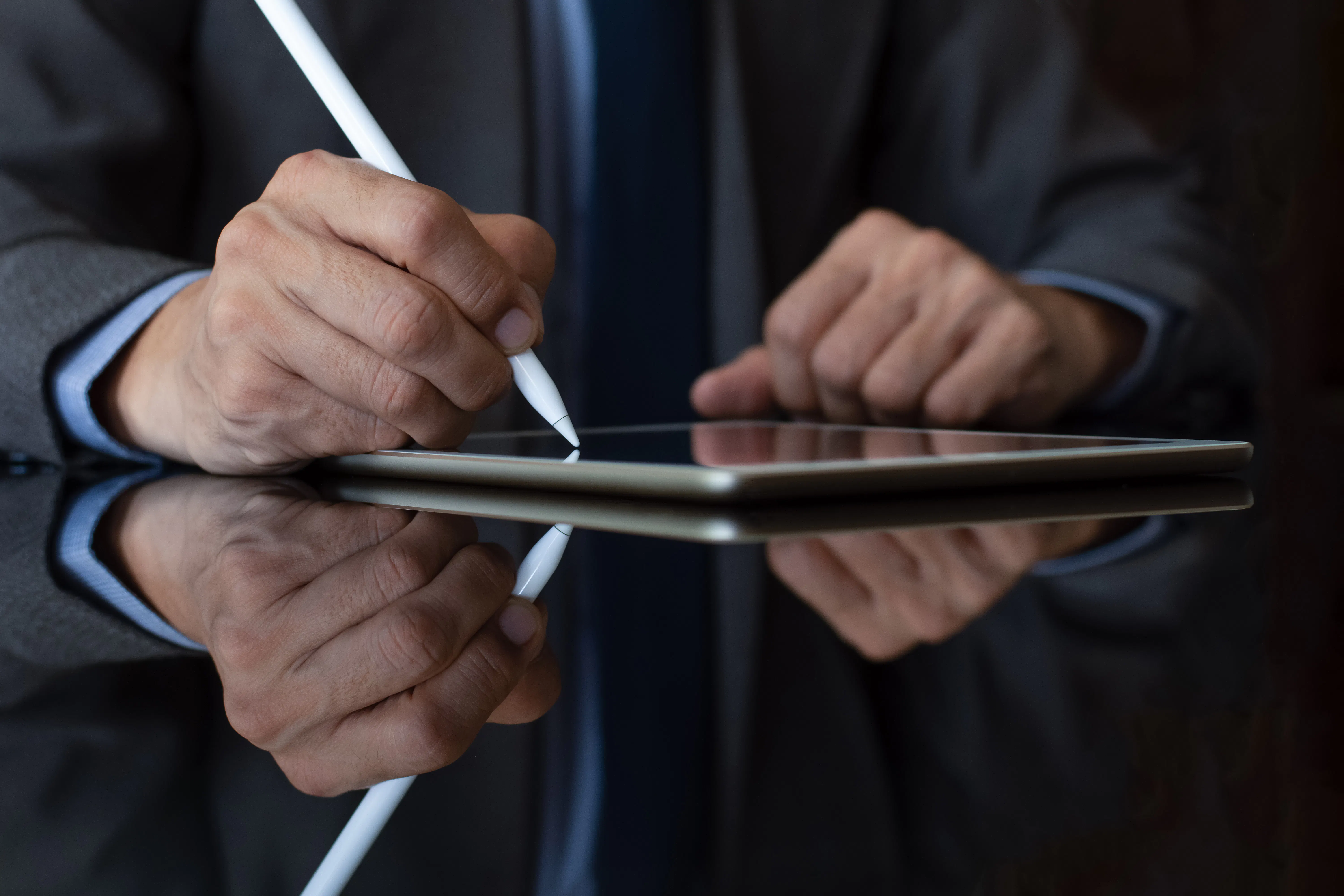 AI generated image of a Business man in suit hand using electronic pen (stylus pencil, digitized pen) sign contract on digital tablet. e-document concept
