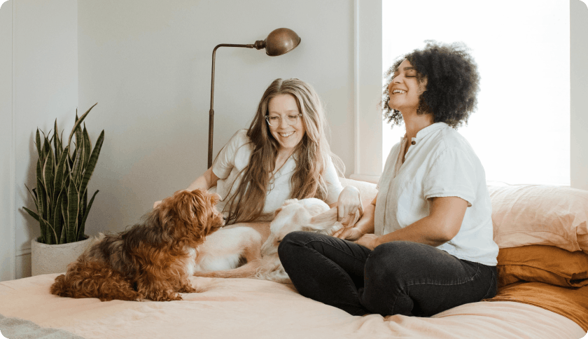 Couple relaxing with their dog after signing him up for dog liability insurance
