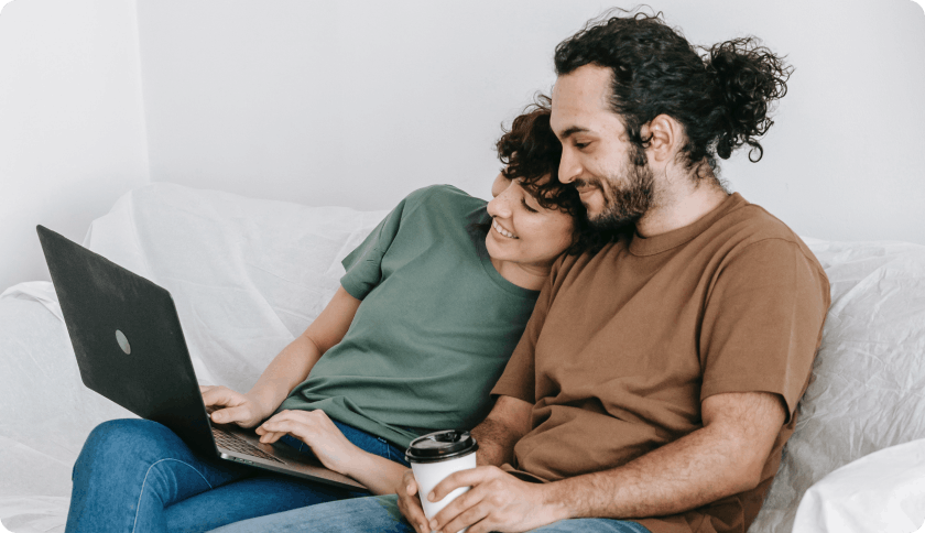Couple sitting on couch and researching insurance