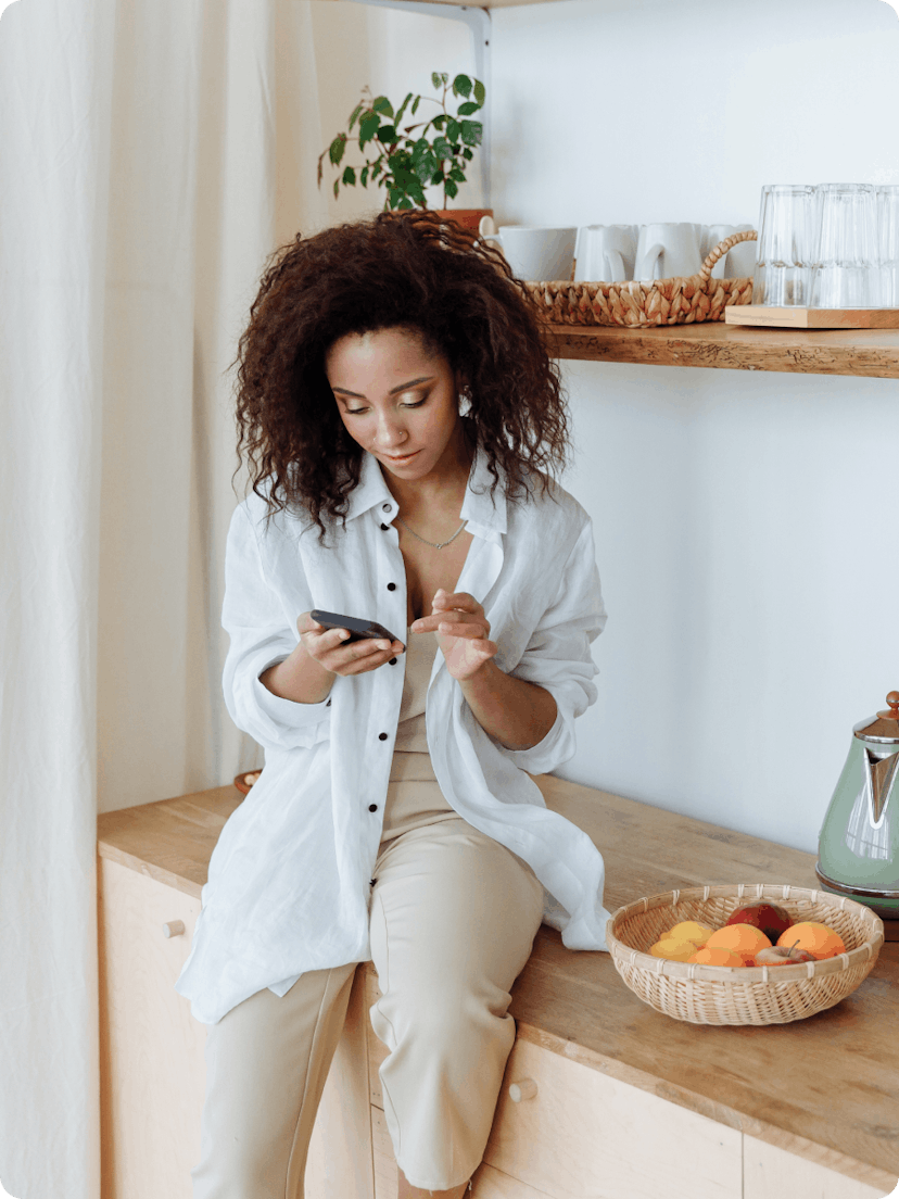 Woman checking her phone and comparing private insurance products