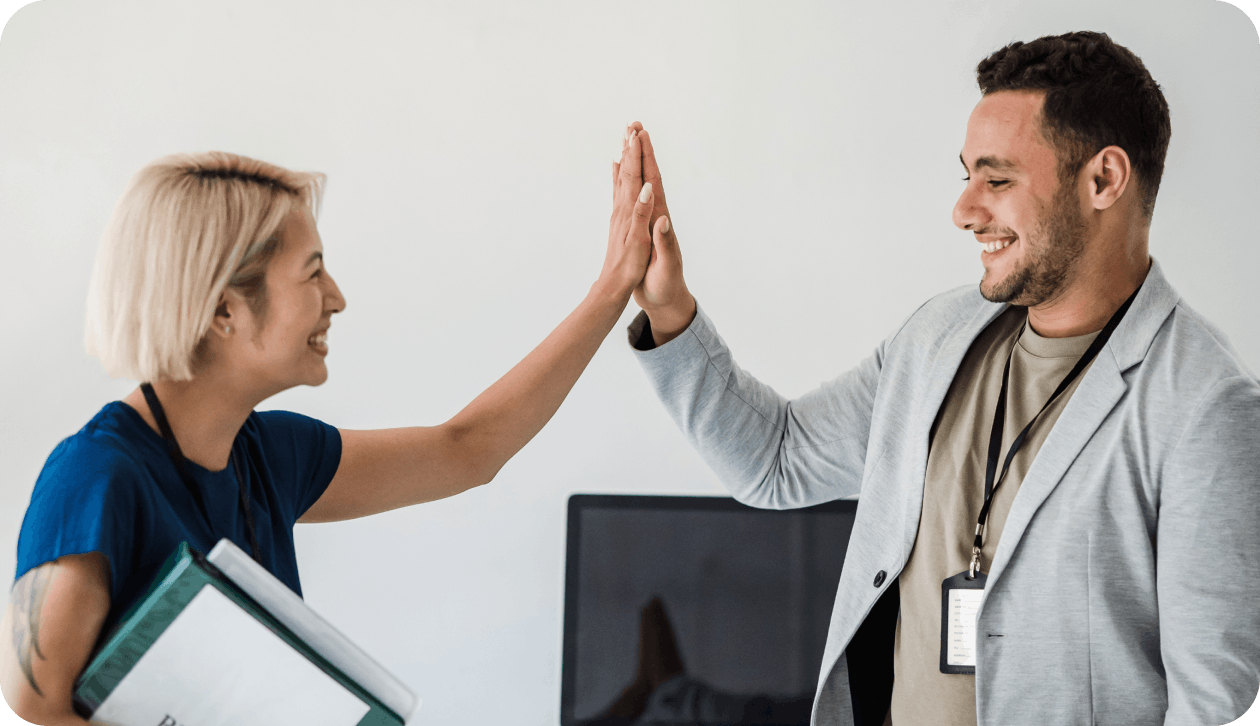 Colleagues clapping hands happily after finding the right insurance plan