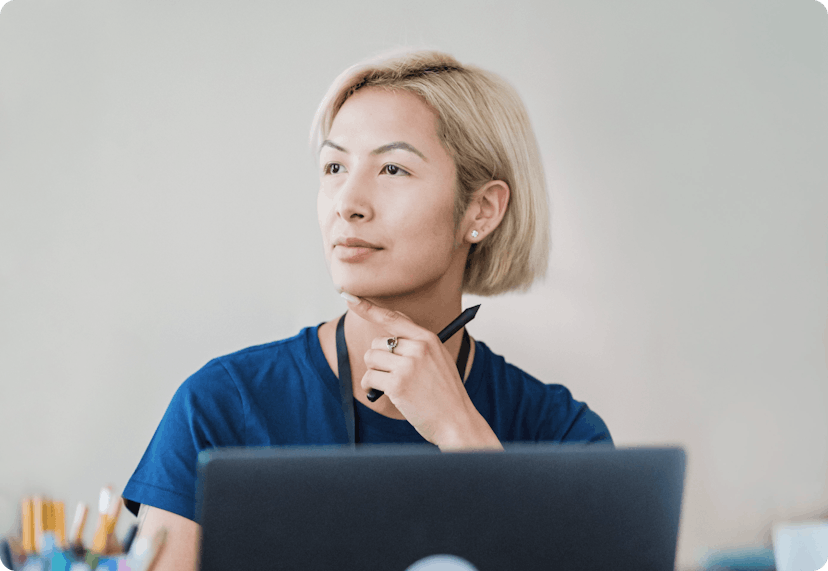 Woman thinking in front of her laptop