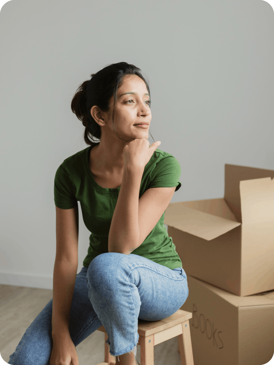 Woman sitting in front of moving boxes