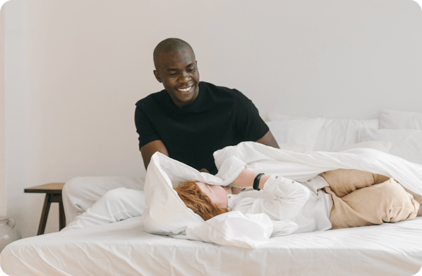 Couple playing in bed