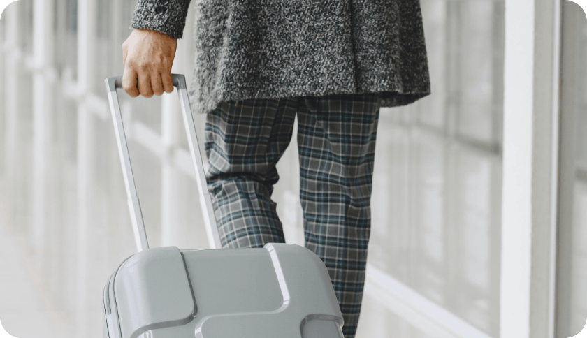 Business traveler rolling luggage