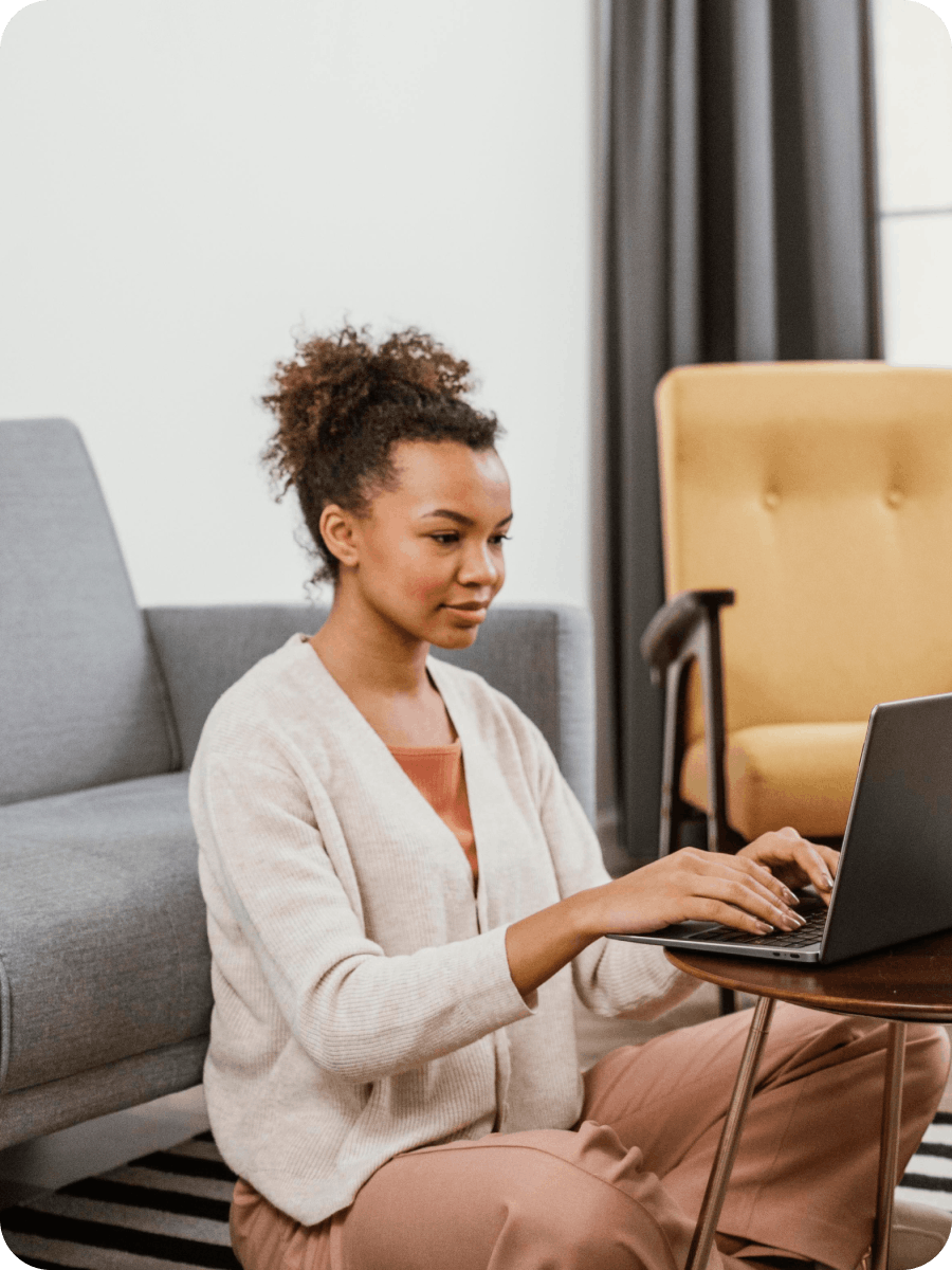Young lady using her laptop in a living room
