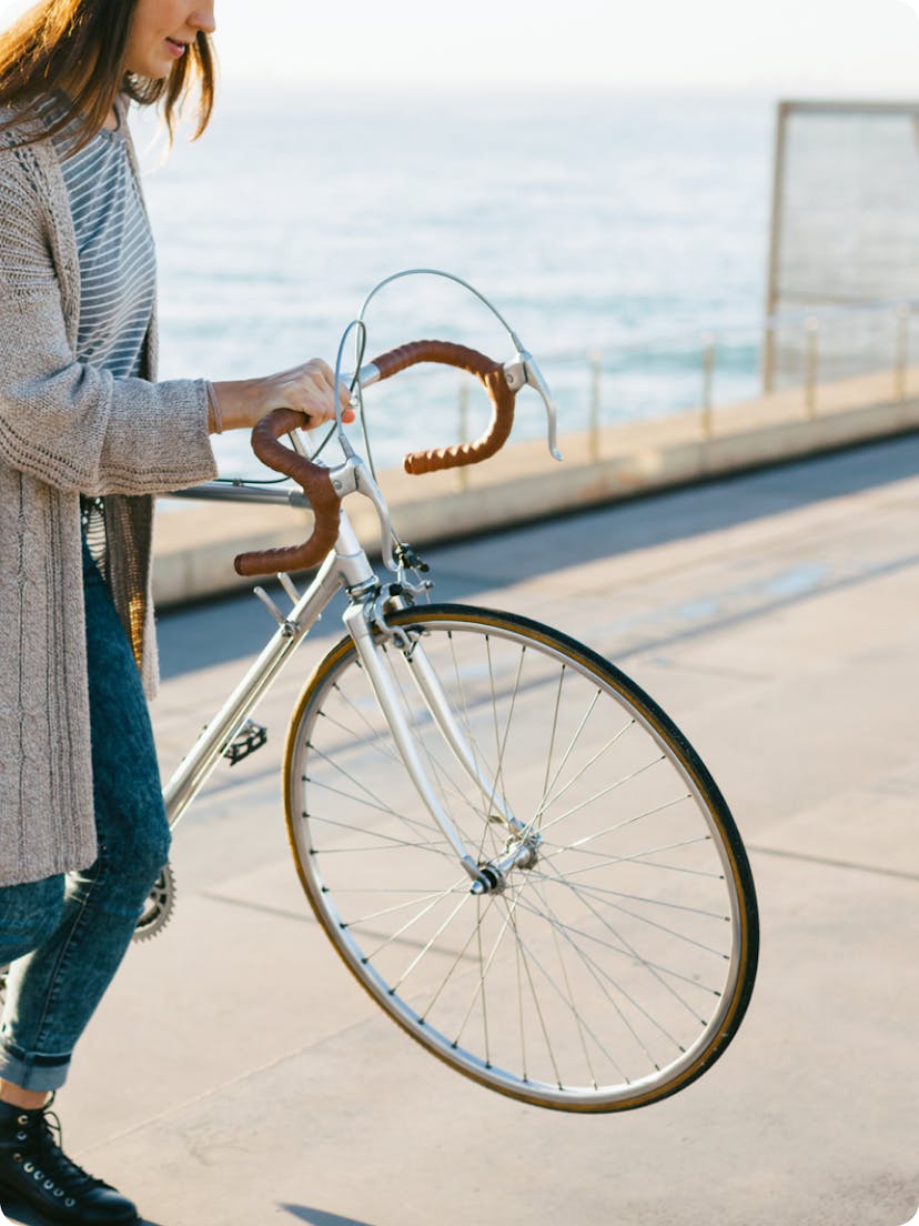 Woman holding her bike.