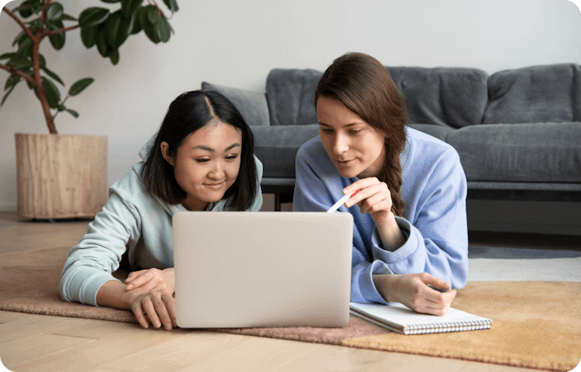 Two women looking at a laptop