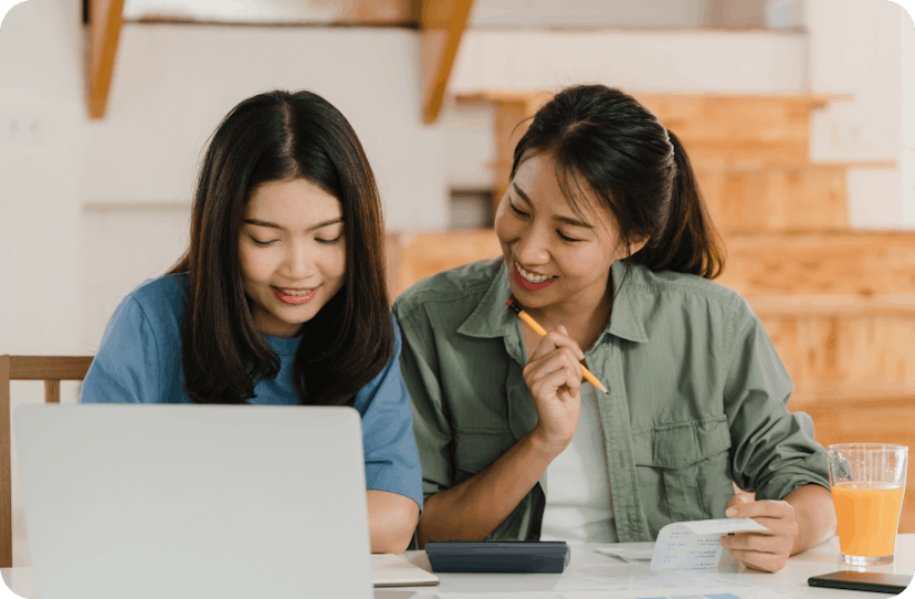 Two friends doing some calculations related to their health insurance