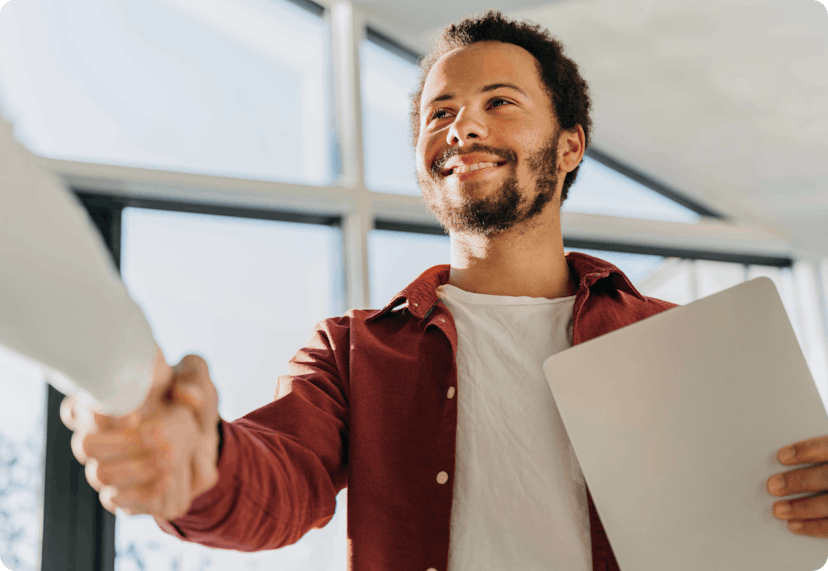 An entrepreneur shaking hands with a potential new client.