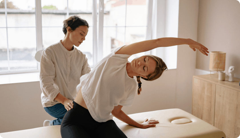 Woman stretching with the help of her occupational therapist