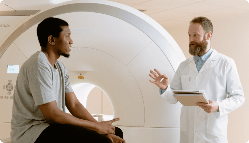 Doctor explaining how an MRI works to patient before the scan