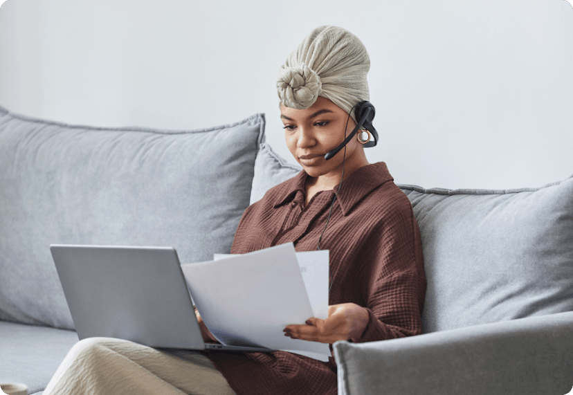 Woman on her couch working remotely