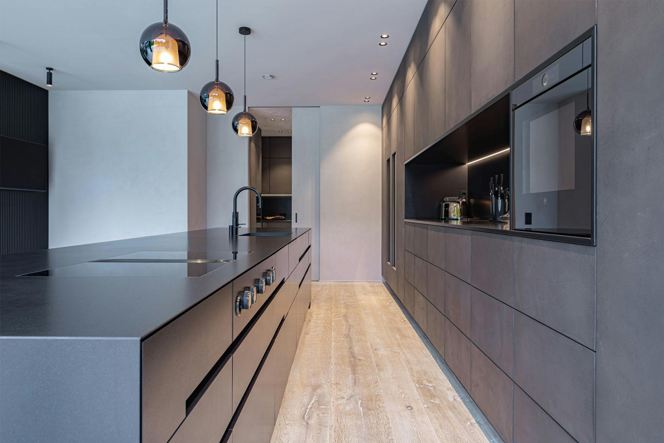 Natural stone kitchen consisting of natural stone monoblock and back wall with troweled concrete fronts