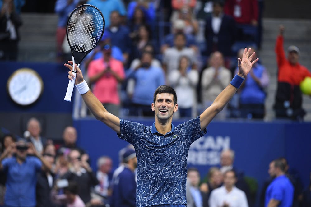 Novak Djokovic hands up after wiing the 2018 US Open