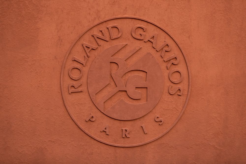 The Roland-Garros logo on the clay wall