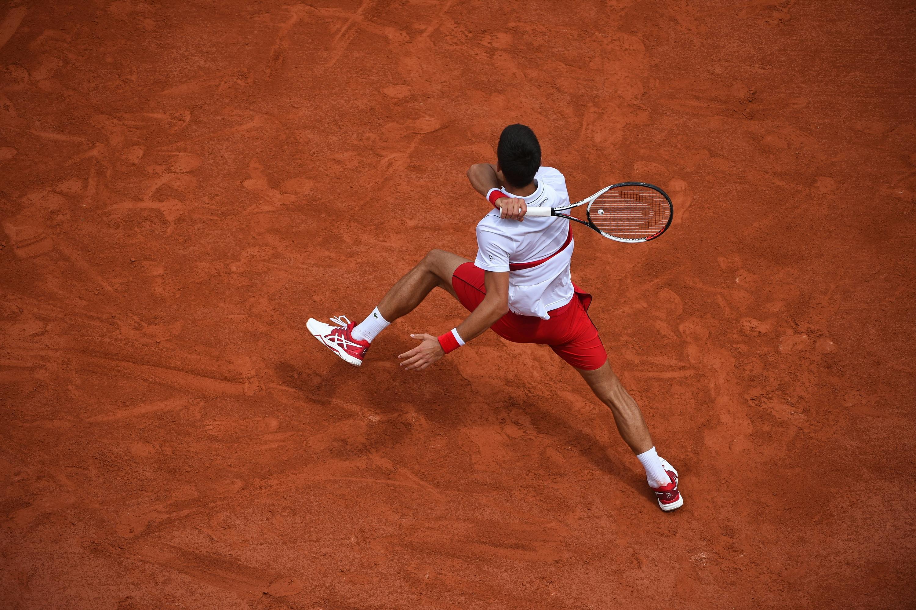 Dislocated Novak Djokovic hitting a forehand at Roland-Garros 2018
