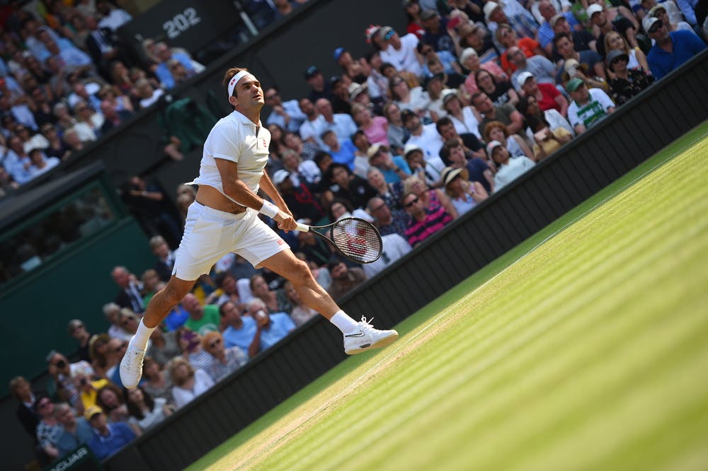 Artistic serving Roger Federer at Wimbledon 2019