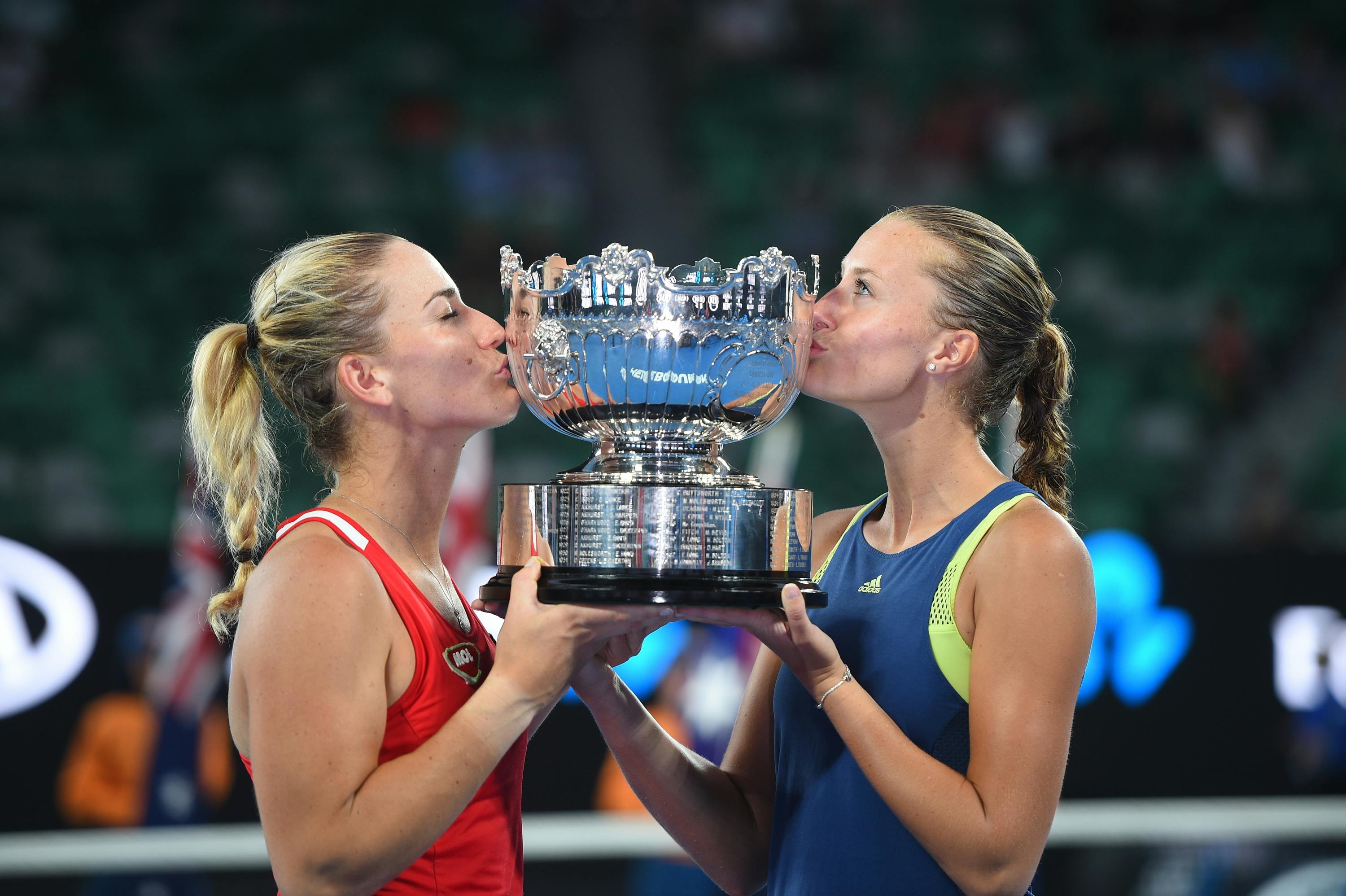 Timea Babos and Kristina Mladenovic kiss the 2018 Australian Open women's double trophy