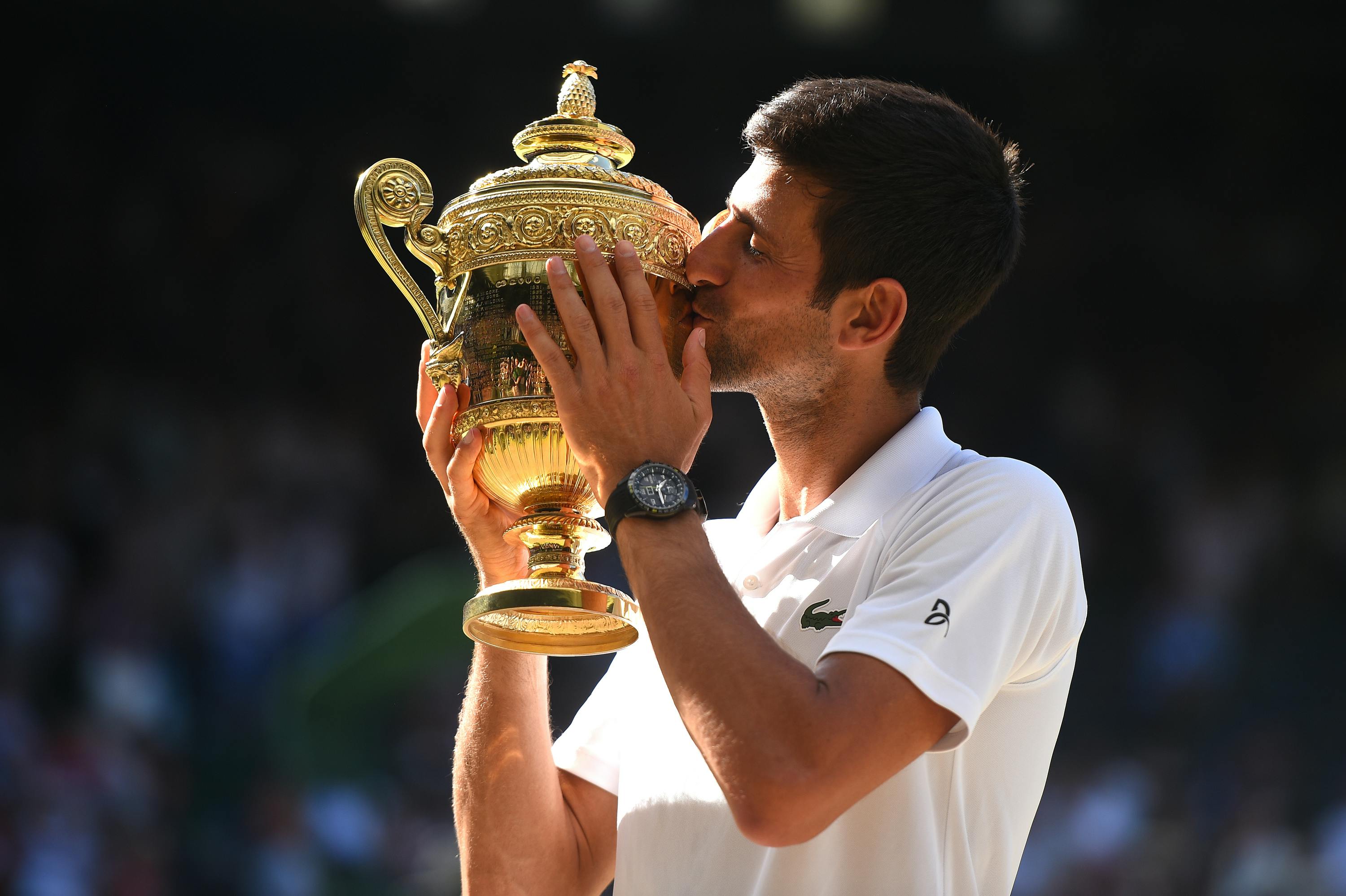 Novak Djokovic kissing the Wimbledon trophy Wimbledon 2018