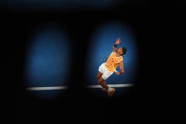 Rafael Nadal serving in the shadow during his third round match against Alex de Mianur at the Australian Open 2019.