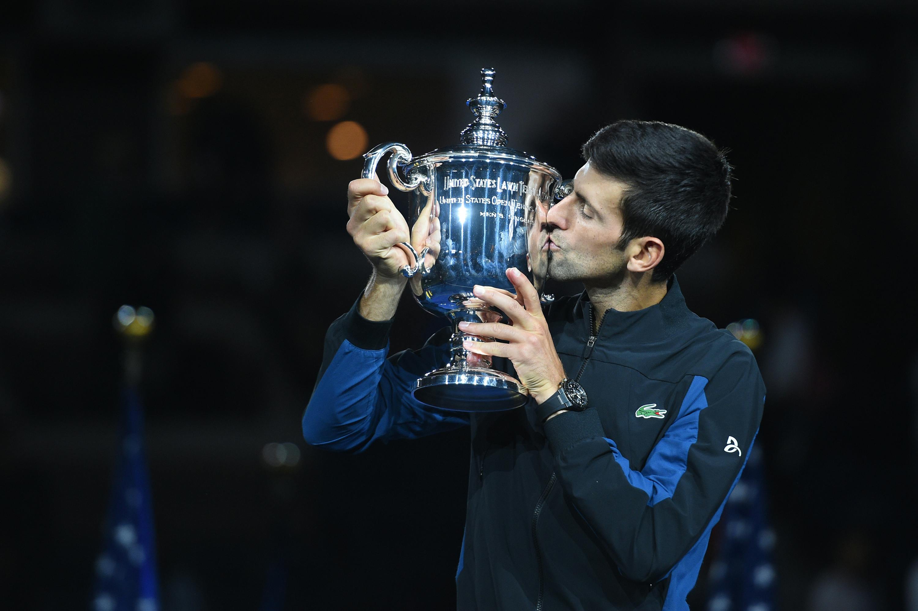 Novak Djokovic kisses the 2018 US Open trophy