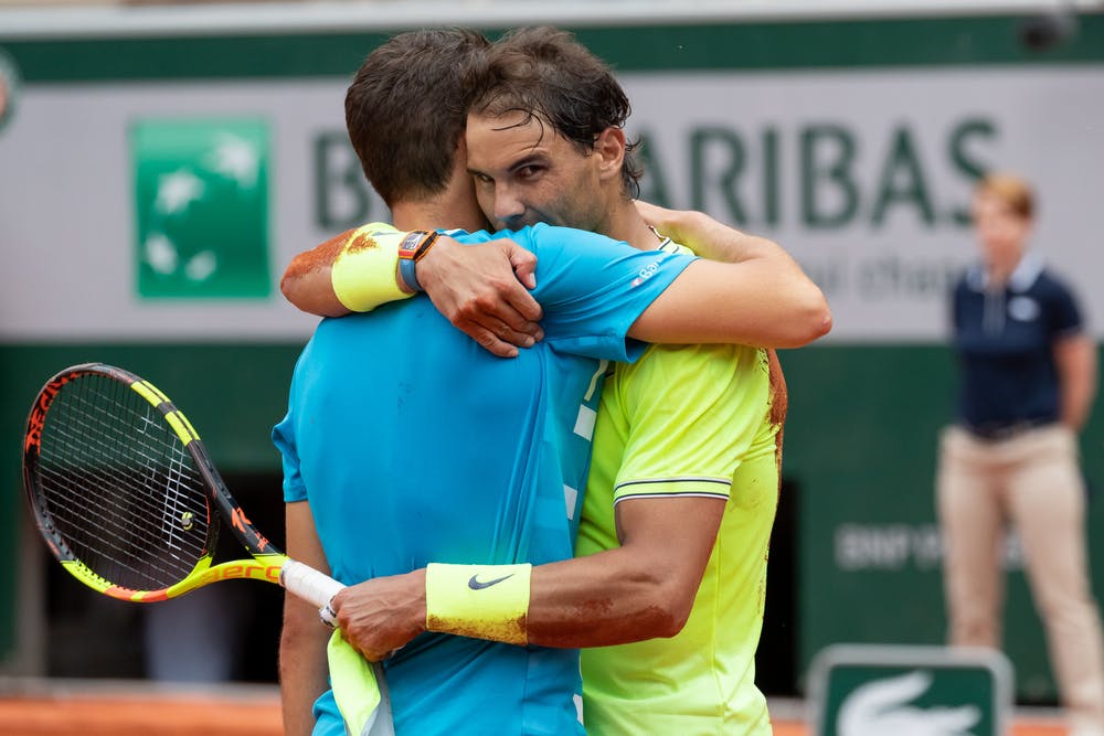Rafael Nadal and Dominic Thiem holding after match point at 2019 Roland-Garros
