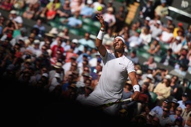 Rafael Nadal serving half in the light, half in the shadow Wimbledon 2019