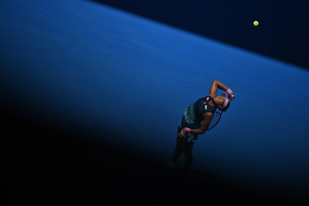 Naomi Osaka serving in the shadow during the Australian Open 2019