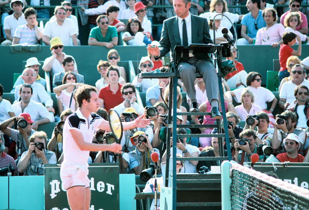 John McEnroe with the referee during the final at Roland-Garros 1984