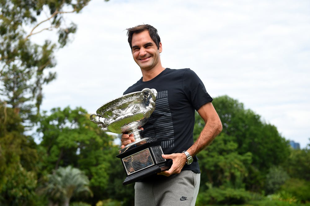 Roger Federer laughing with his Australian Open 2018 trophy the day after