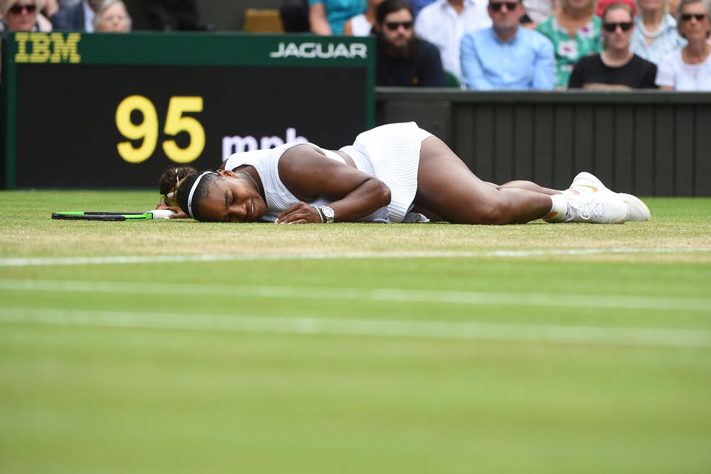 Serena Williams lyong on the grass at Wimbledon 2019
