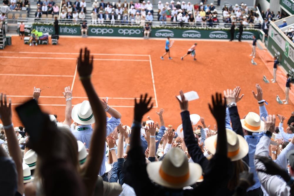 Crowd waving on the Court Philippe-Chatrier during Roland-Garros 2019