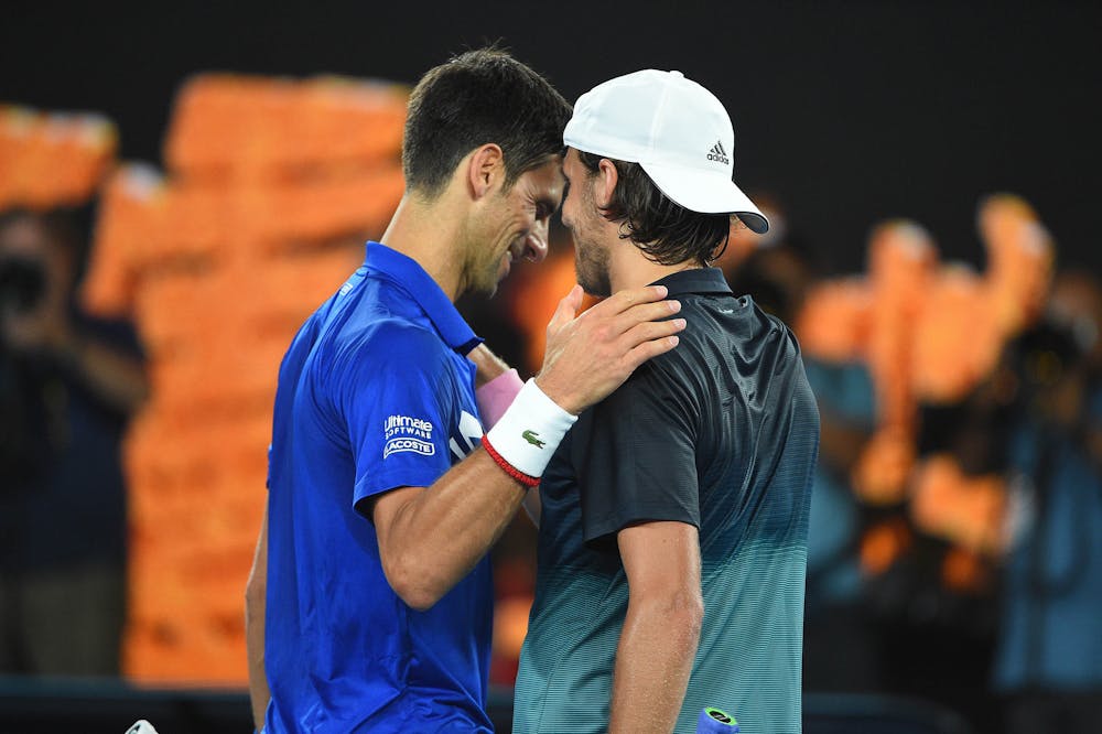 Novak Djokovic and Lucas Pouille at the net during 2019 Australian Open