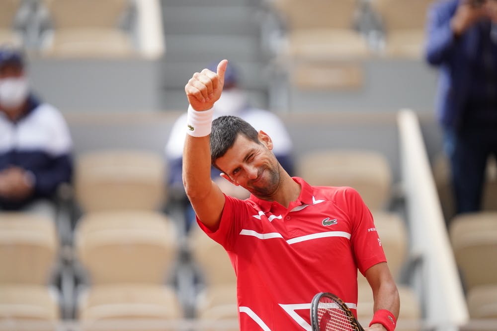 Novak Djokovic smiling and blinking during Roland-Garros 2020.