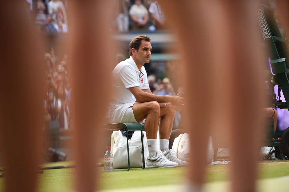 A sad Roger Federer sitting during the trophy presentation at Wimbledon 2019