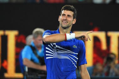 Novak Djokovic smiling after winning his semifinal at the 2019 Australian Open