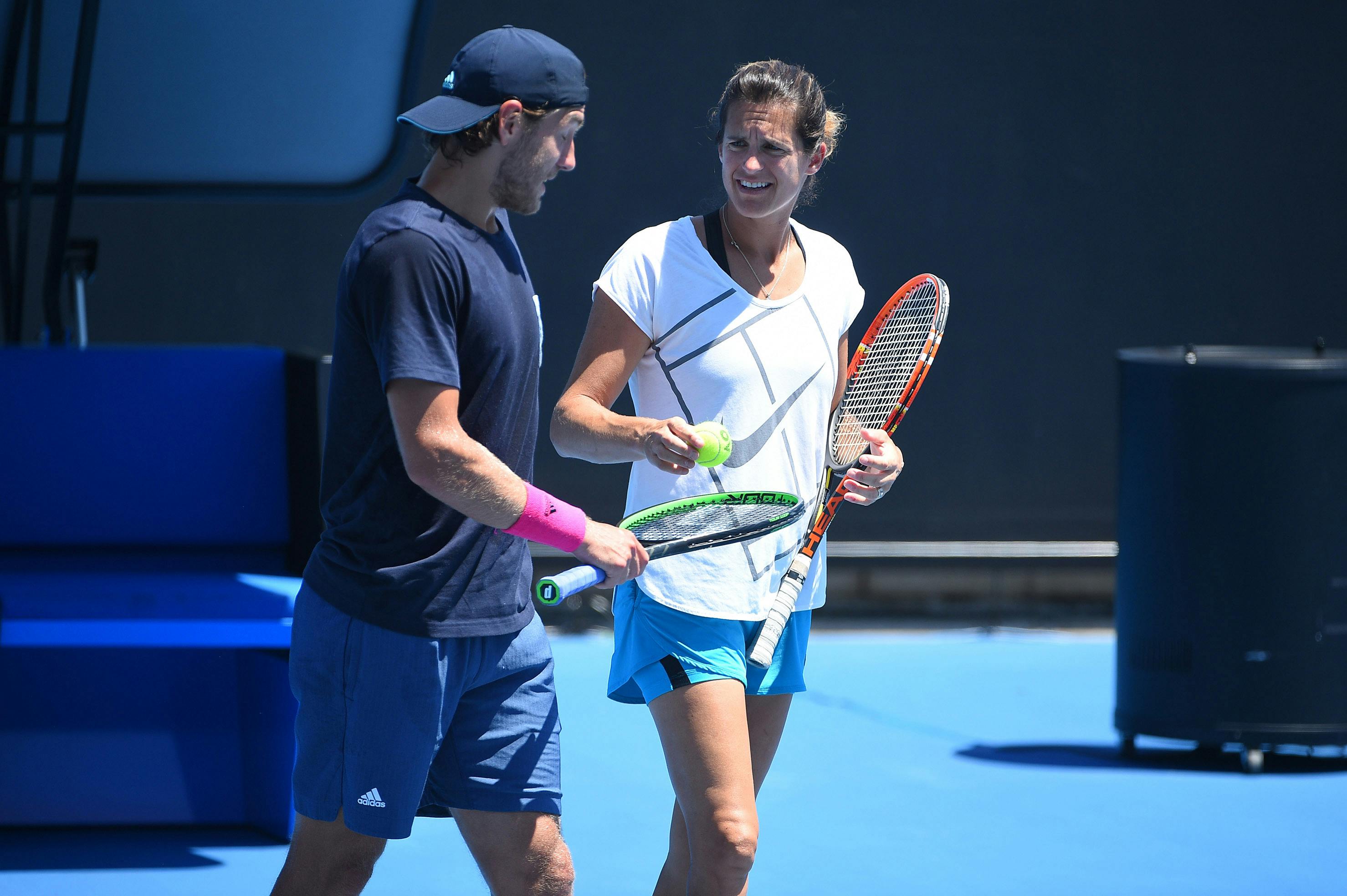 Amelie Mauresmo and Lucas Pouille talking during practice at the 2019 Australian Open