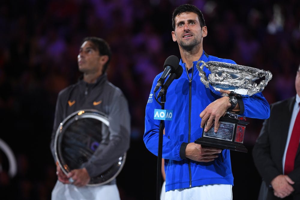 Novak Djokovic doing his post victory speach with Rafael Nadal in the back at the US Open 2019