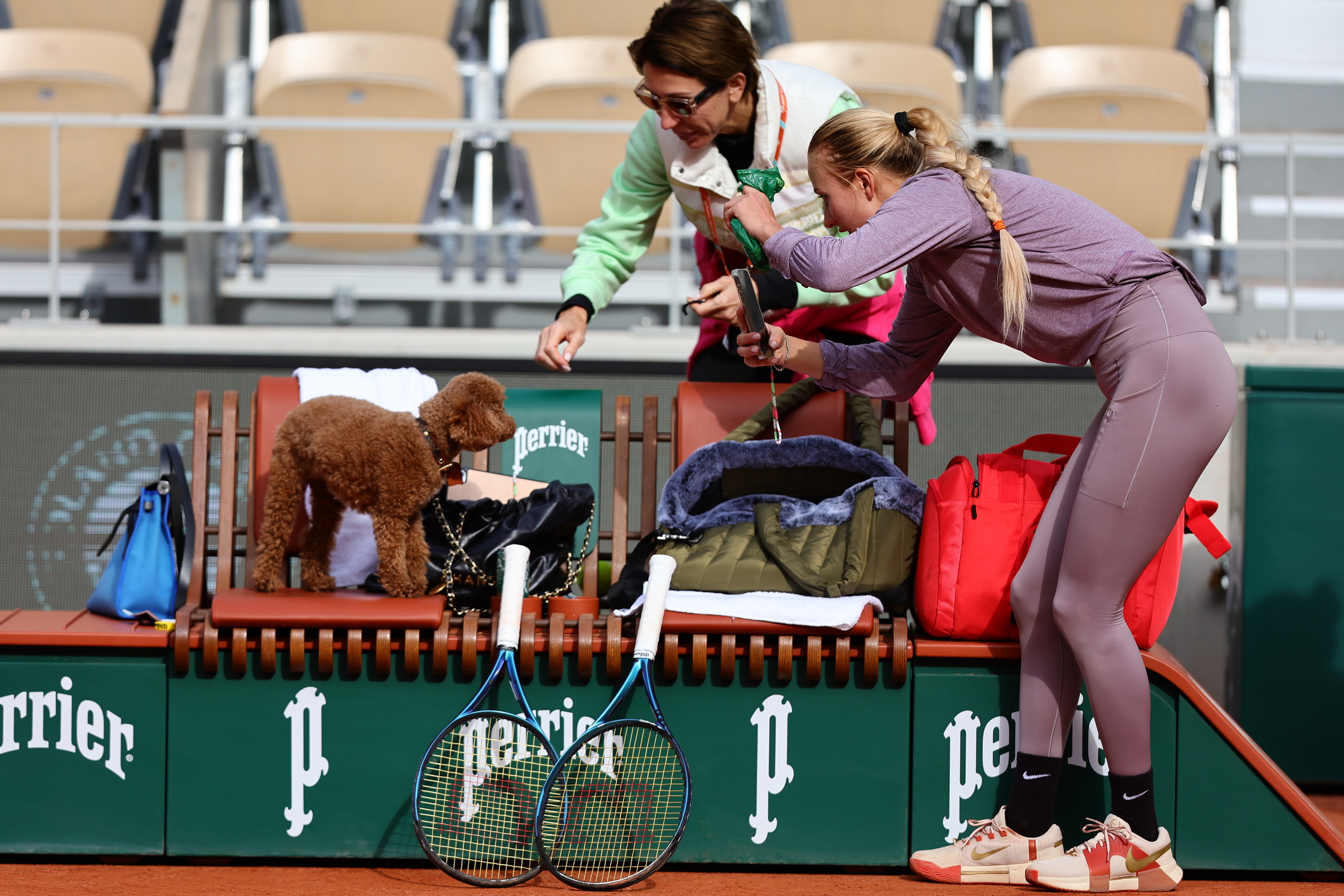 Anastasia Potapova with her dog on the practice court