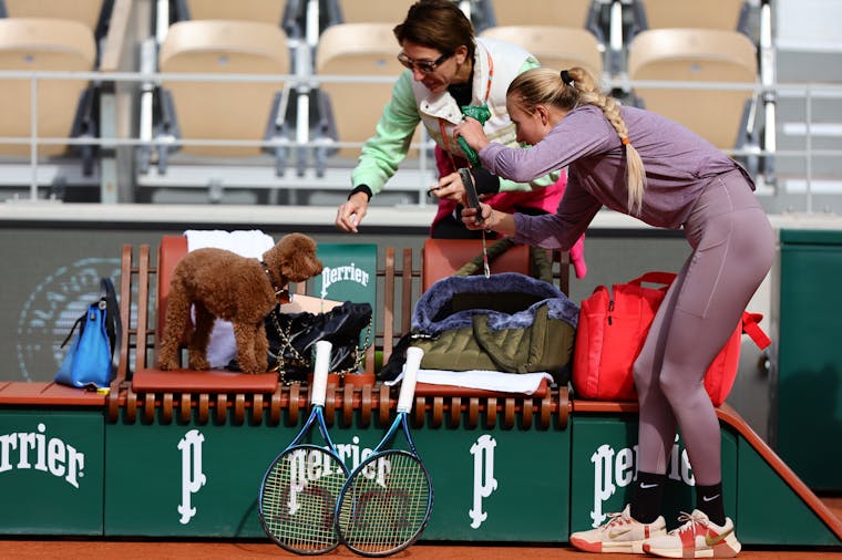 Anastasia Potapova with her dog on the practice court