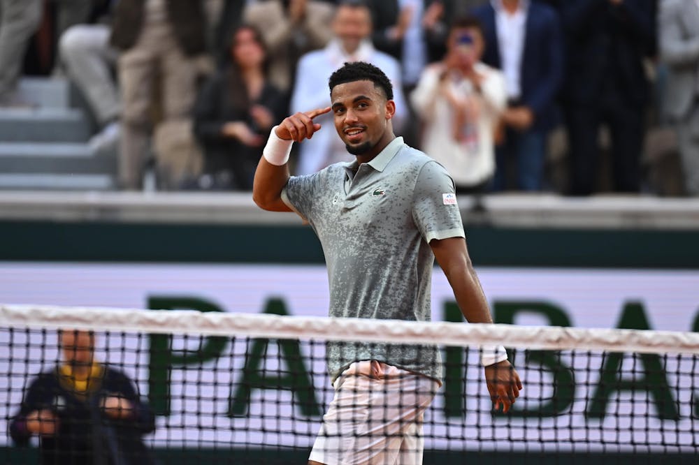 Arthur Fils points to his head during his first round win over Nicolas Jarry