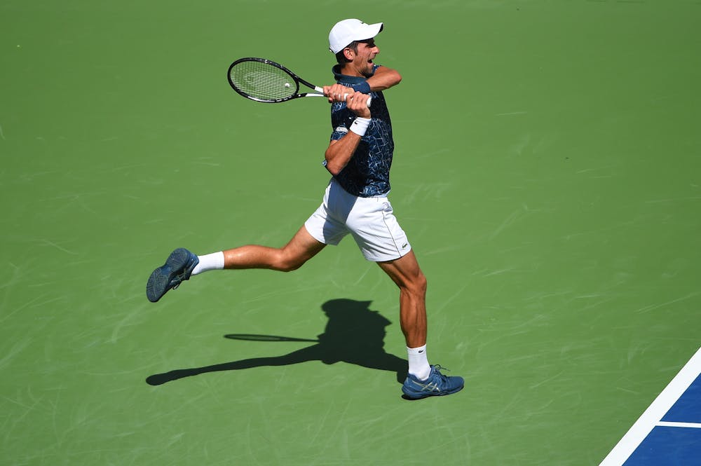 Novak Djokovic playing a backhand at the first round of the US Open 2018